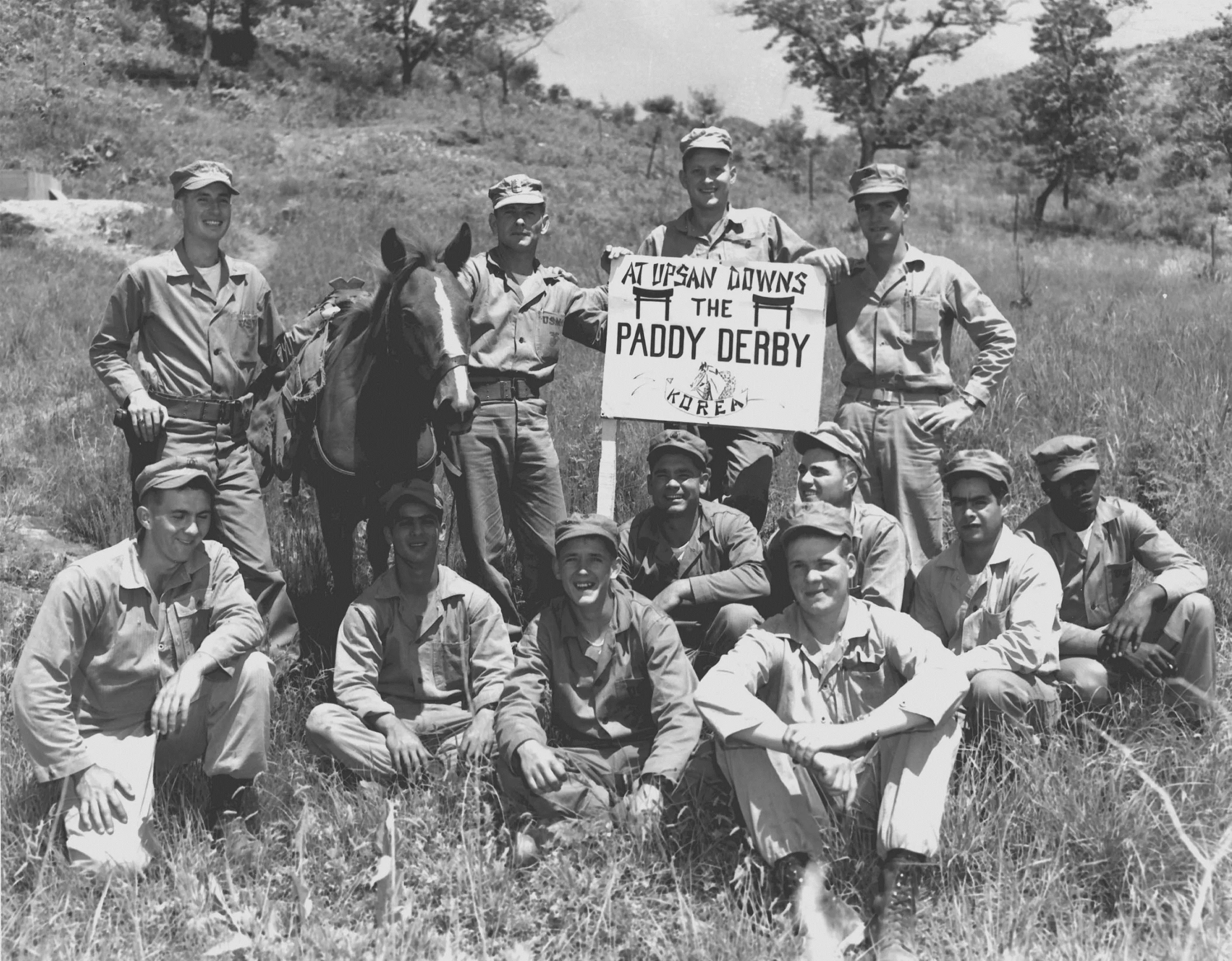 Sergeant Reckless with Sergeant Lively’s squad in Korea, 1955. U.S. Marine Corps Archives. Public domain, Wikimedia Commons.