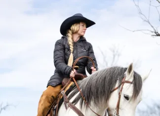 Rooted in Connection A rider works a horse over a log at Cross Brand Cowboy Church.