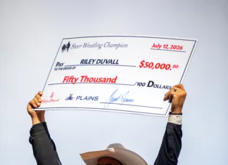 A Family Tradition of Champions Riley Duvall holds up his big check after his big win.