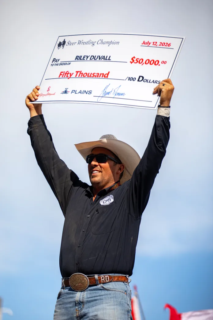 Riley Duvall holds up his big check after his big win.