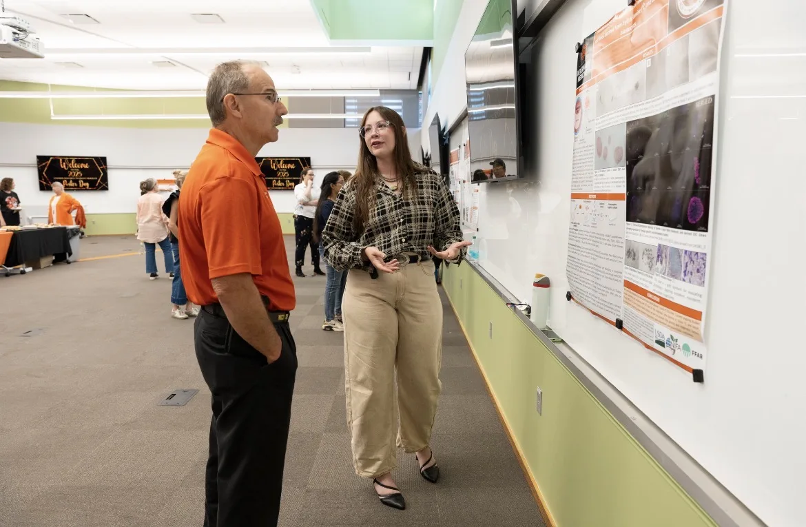 Burba listening to Wilkinson present her research findings. Photo courtesy of Jade Wilkinson.