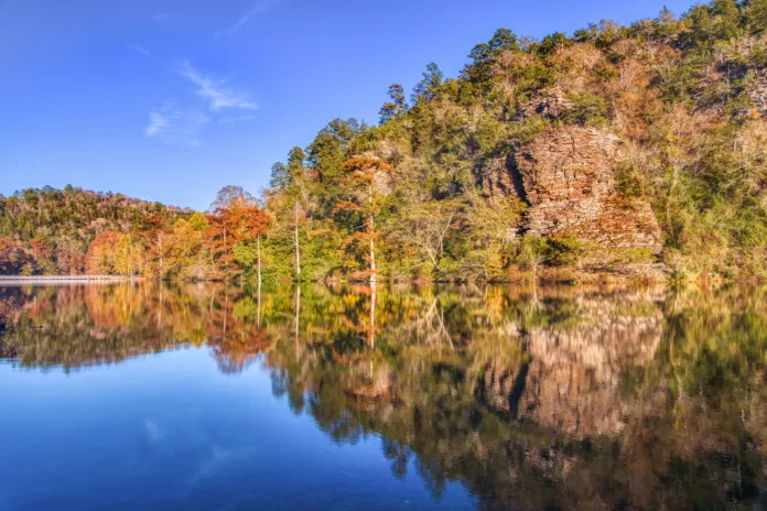 AdobeStock_547091645 An Oklahoma lake framed by autumn timber and a rocky bluff.