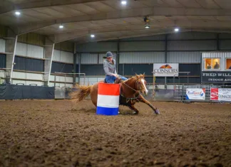 Fall Competition Comes to Connors State College A barrel racer rounds a barrel in the Fred Williams Arena at Connors State College.