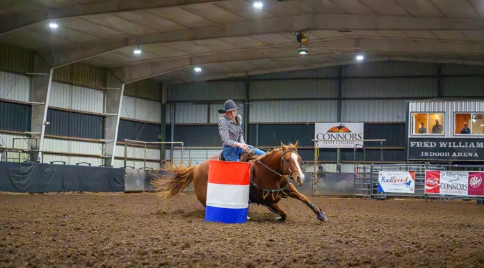 Fall Competition Comes to Connors State College A barrel racer rounds a barrel in the Fred Williams Arena at Connors State College.