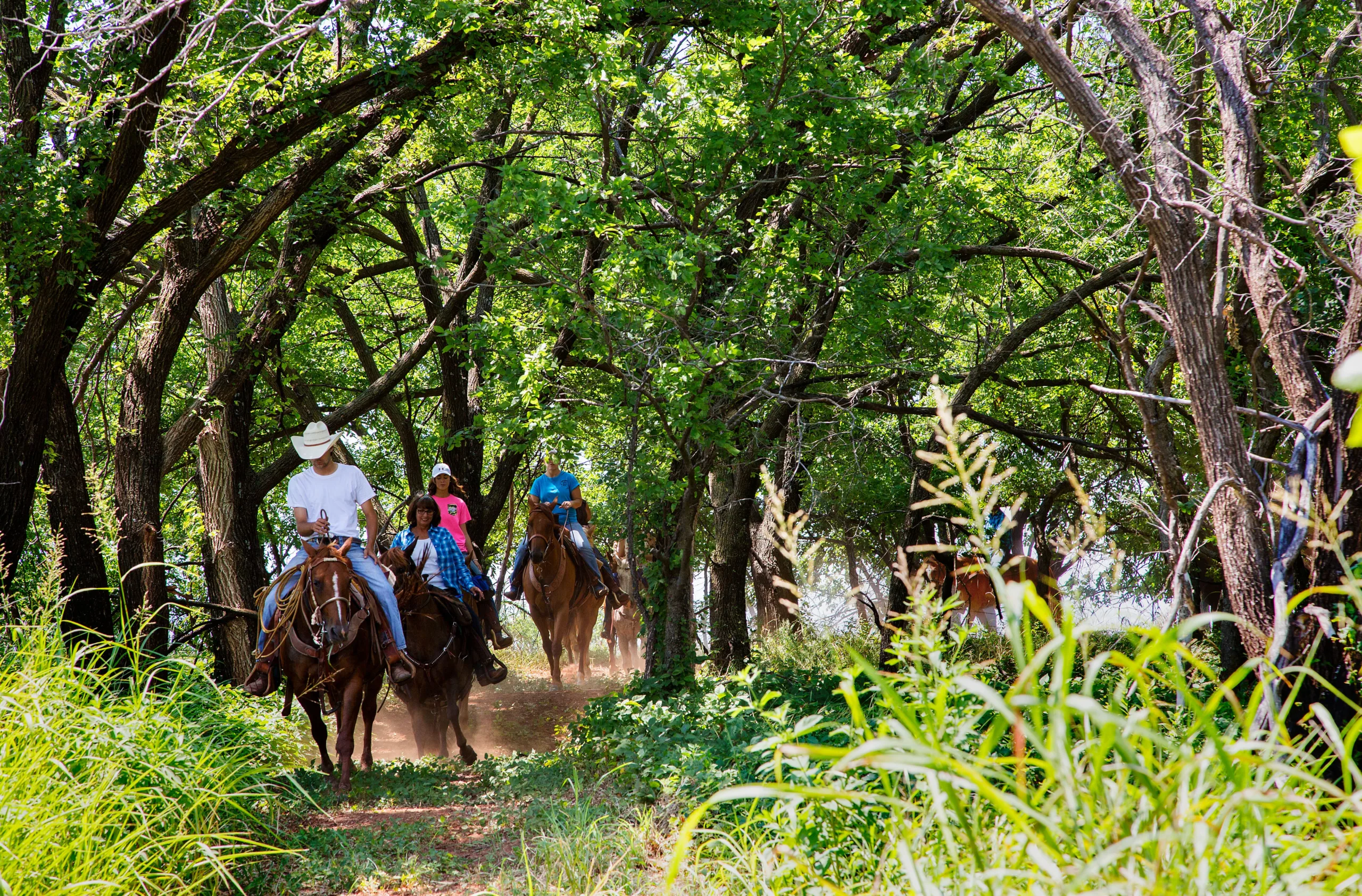 Riders on a shaded trail at Foss State Park.