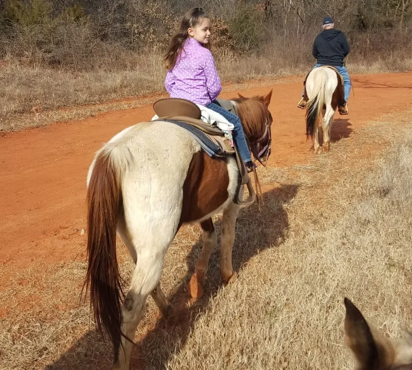 A young rider on a trail at The Riding Stables at Draper Lake in Oklahoma City.
